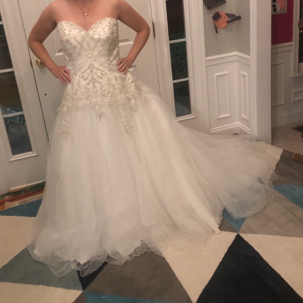 Size 18 wedding dress. Color is ivory/silver. Worn once.